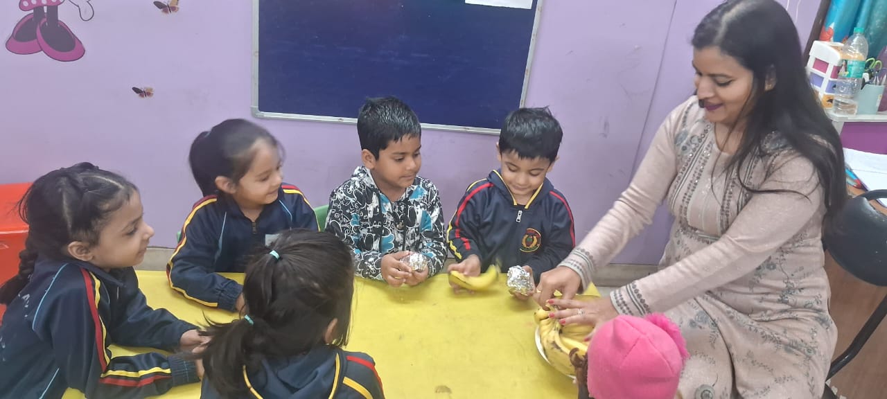 Children sitting together with bananas on the table
